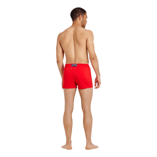 Men Swimwear Short and Fitted Stretch Solid Medicis red back worn view
