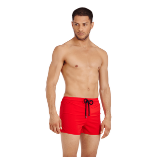 Men Swimwear Short and Fitted Stretch Solid Medicis red front worn view