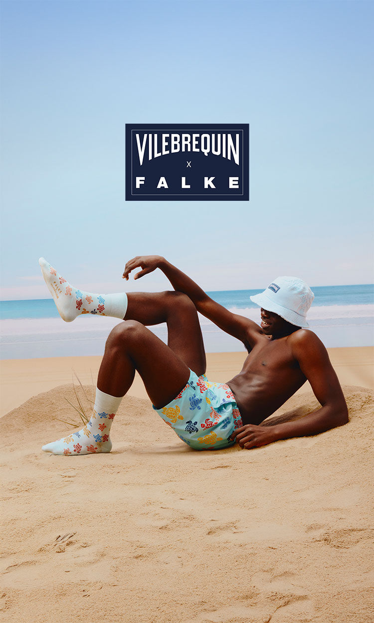 A man wearing Falke x Vilebrequin swimwear and matching socks.