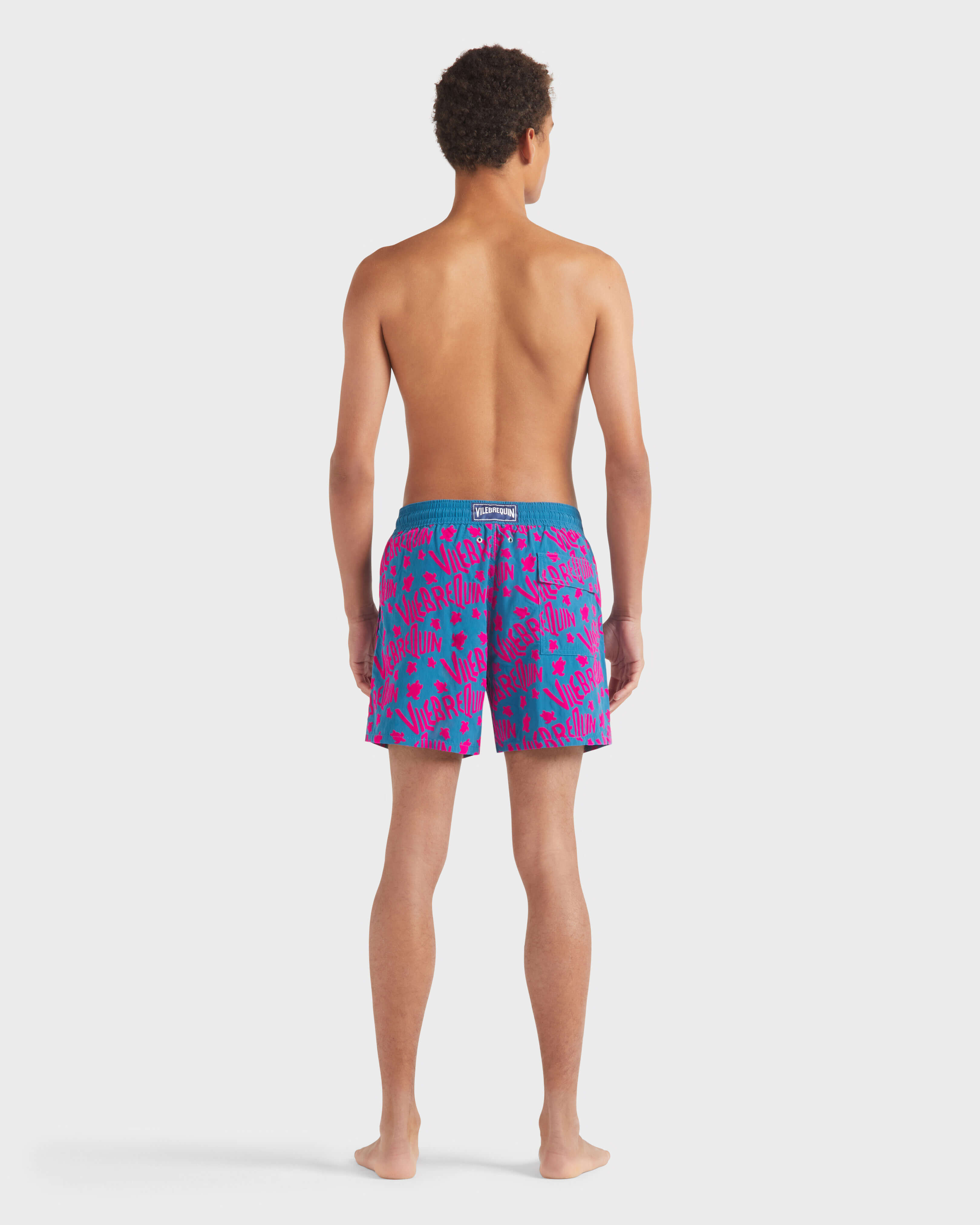 Men Swim Trunks Flocked Ronde Des Tortues Logo PEACOCK backworn view