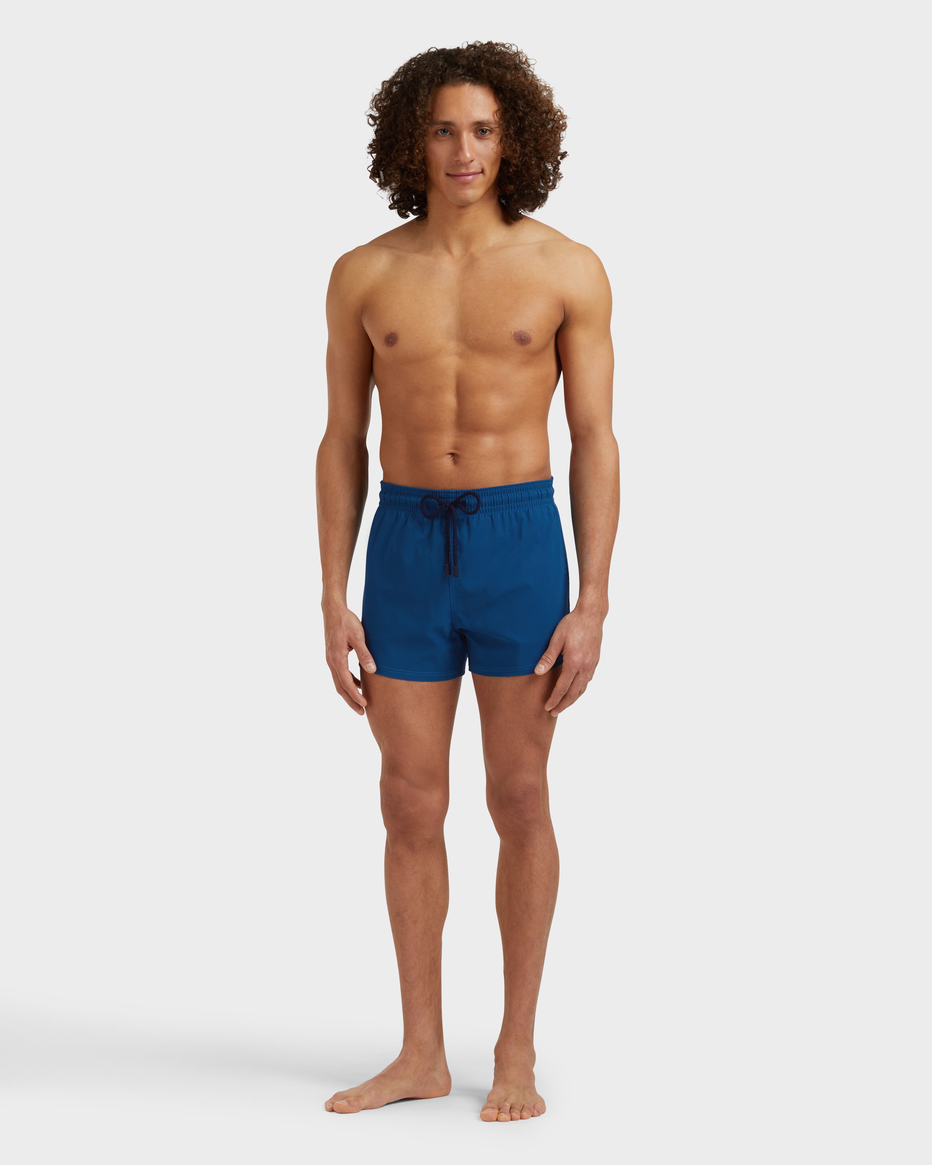 Men Swimwear Short and Fitted Stretch Solid PEACOCK frontworn view