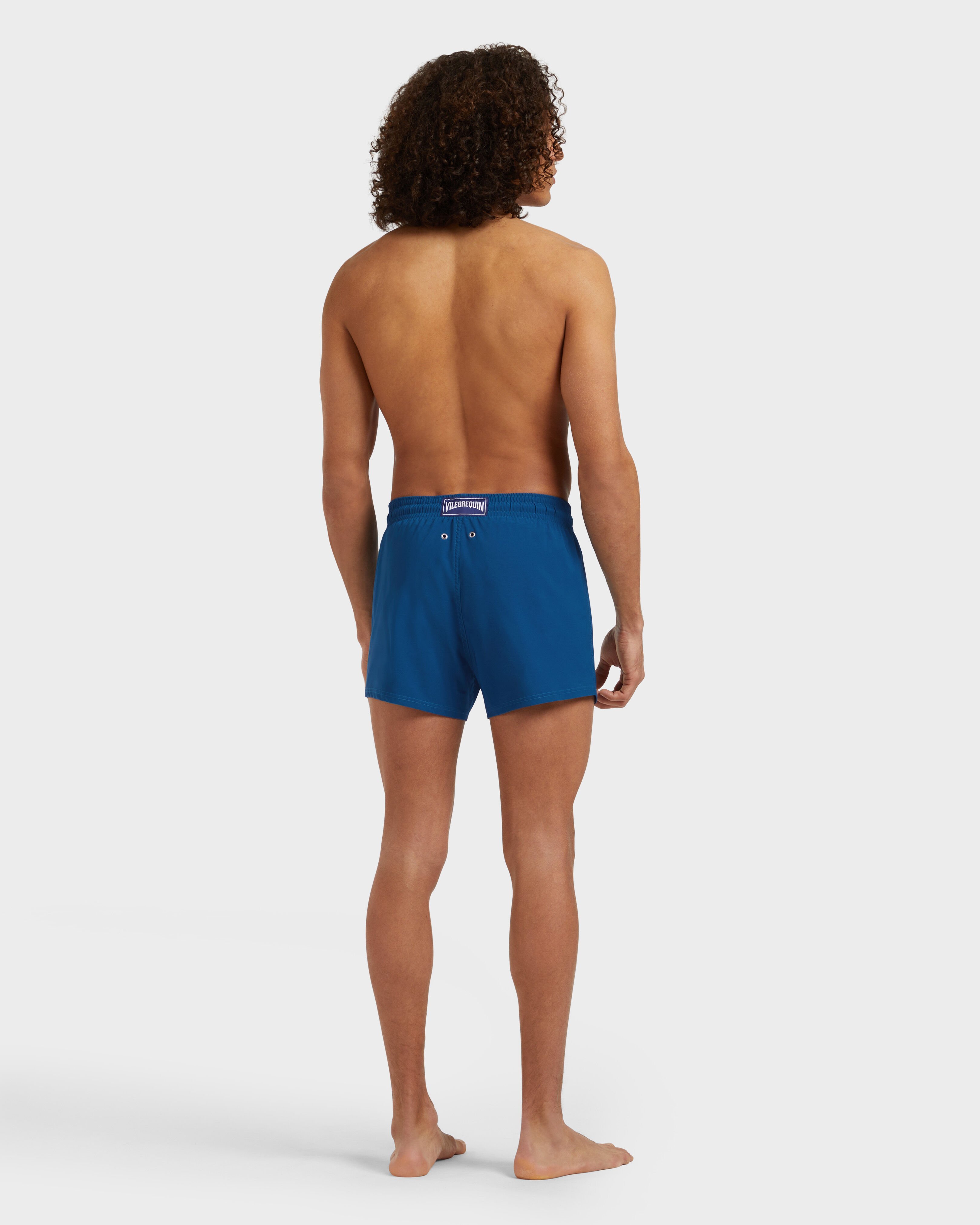 Men Swimwear Short and Fitted Stretch Solid PEACOCK backworn view