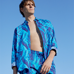 A man wearing the Les Draps Froissés Shirt with the Les Draps Froissés Swimshort
