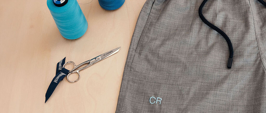 Embroidering a monogram on a men swim short 