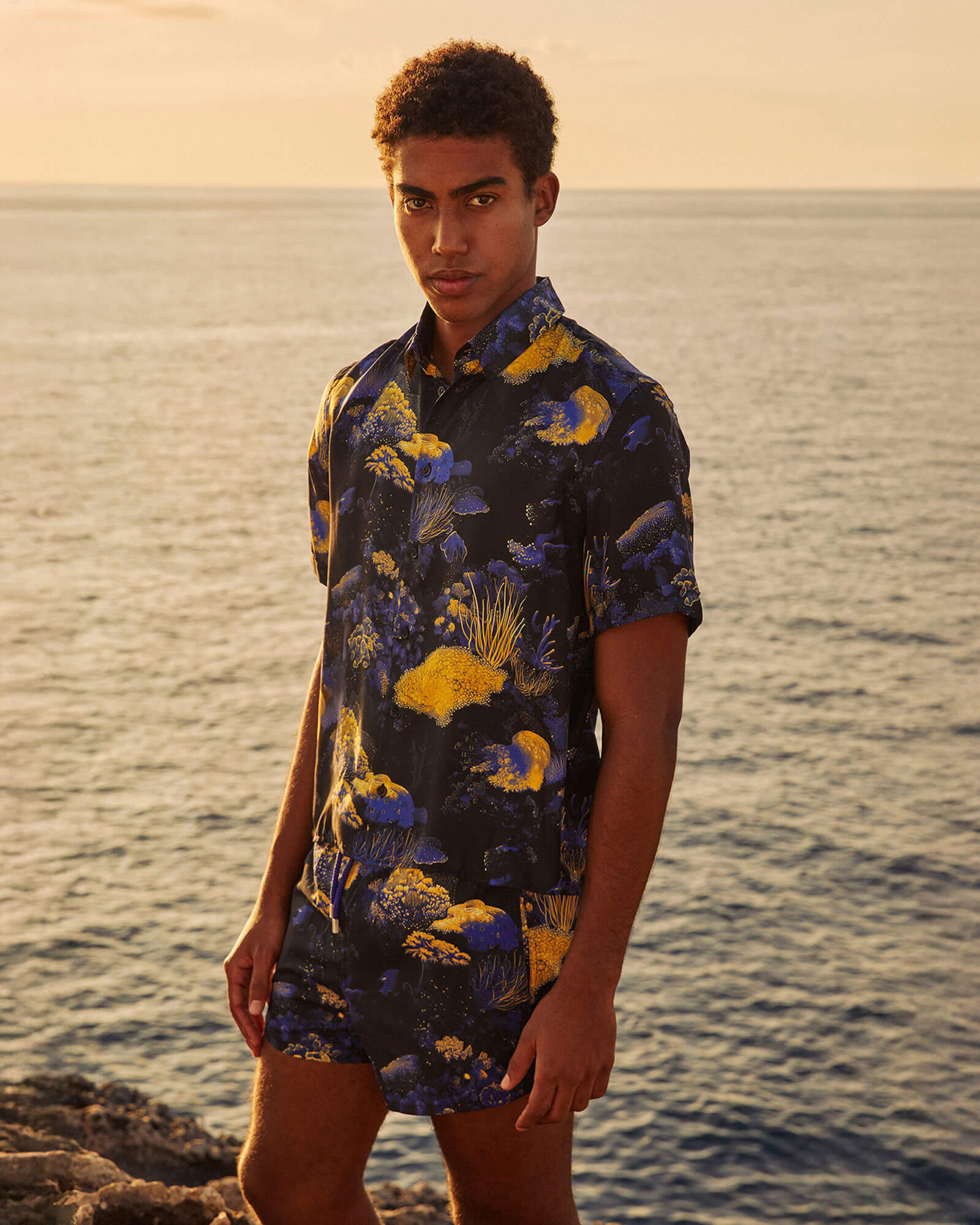 men in the sunset with swimshort
