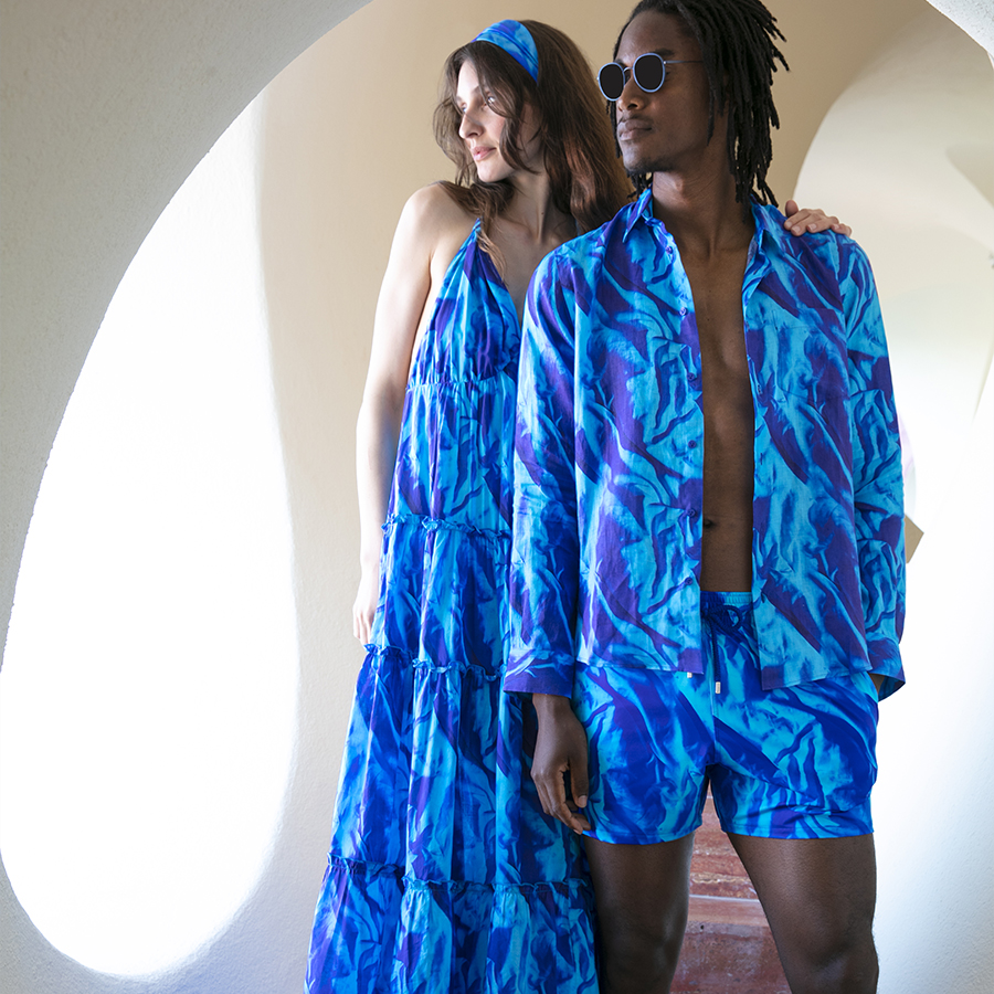 A woman wearing the Women Cotton Long Backless Dress Les Draps Froissés and a man wearing the Shirt and a Swimshort Les Draps Froissés