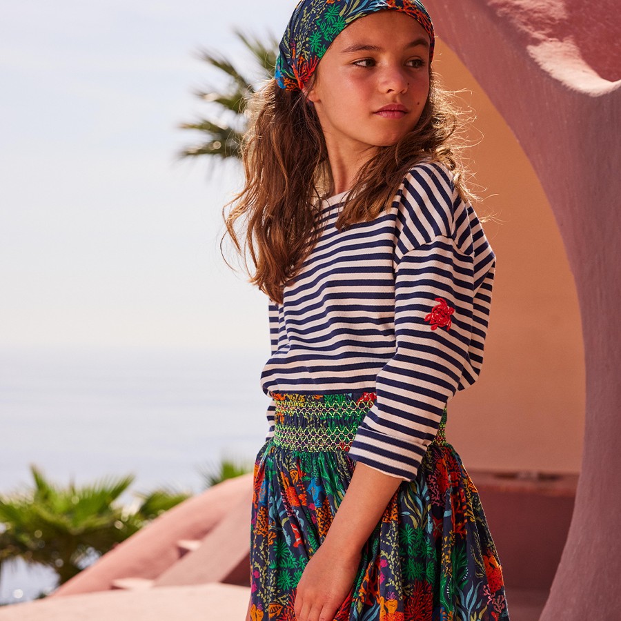 A girl wearing a skirt and a top