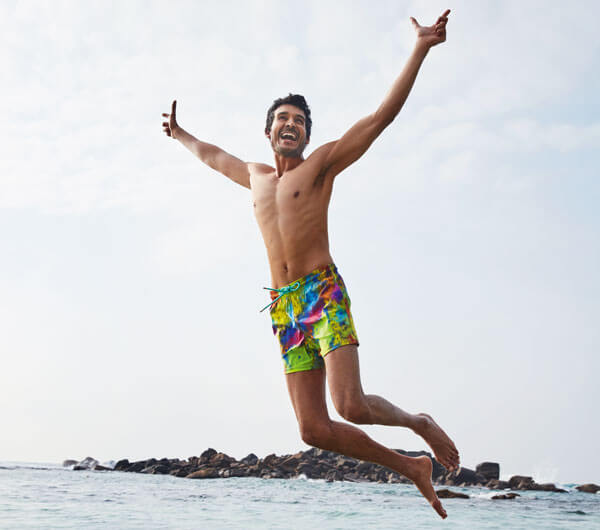 Men New Arrivals A man wearing a blue polo and a green swimwear