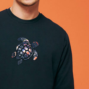 man wearing a Vilebrequin logo sweatshirt