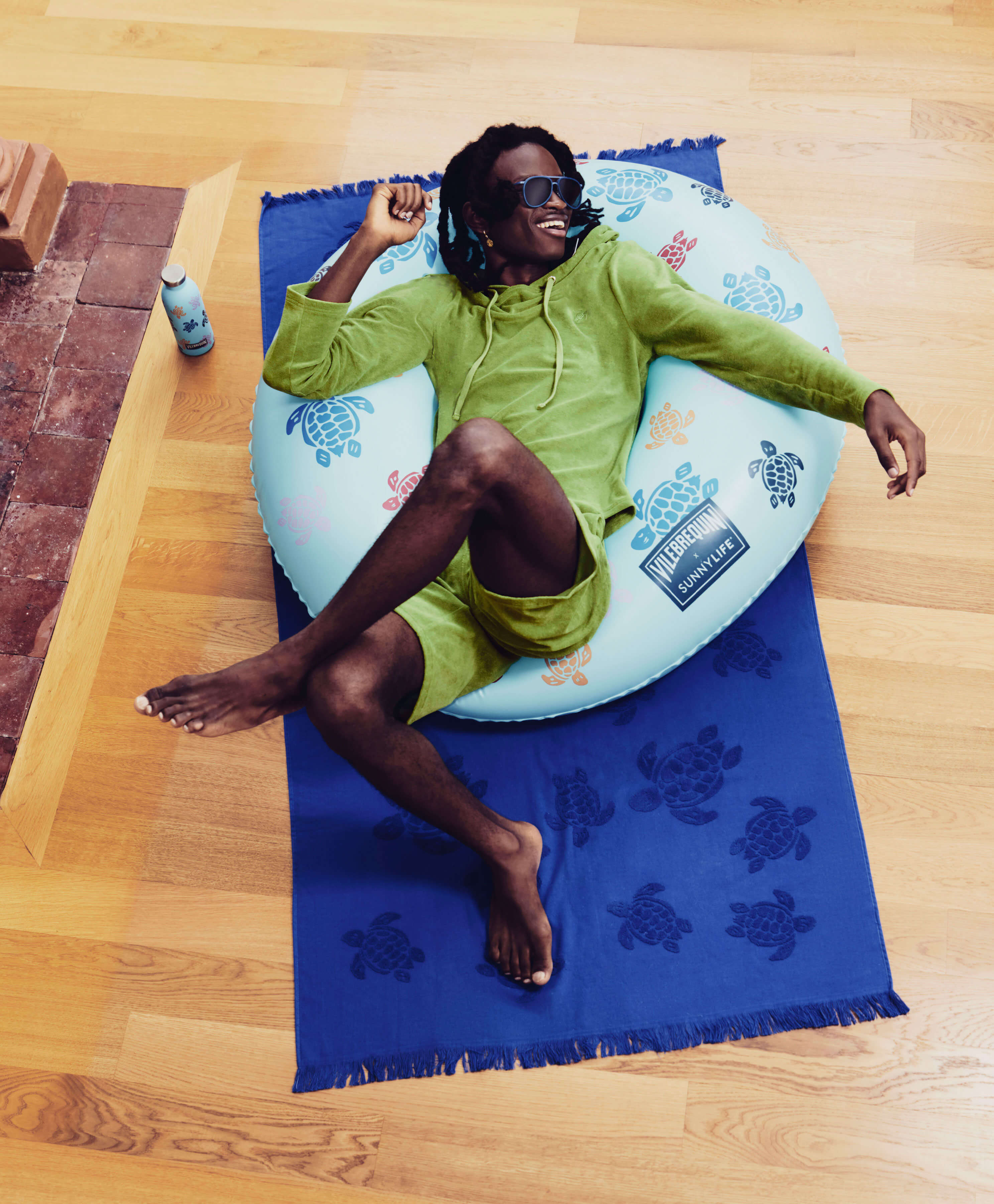 A man in a float, dressed in green.