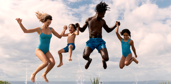 A family of four happily jumping