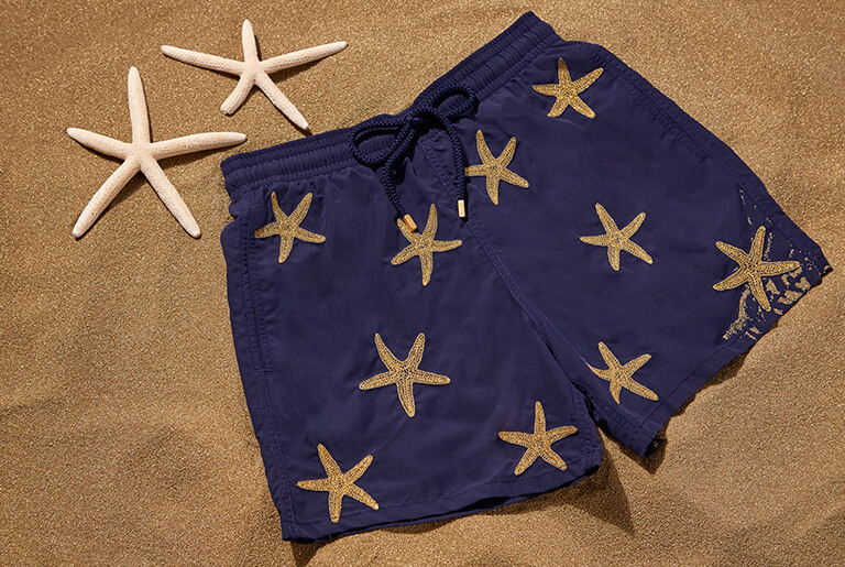 Blue men's swimsuit embroidered with gold starfish threads