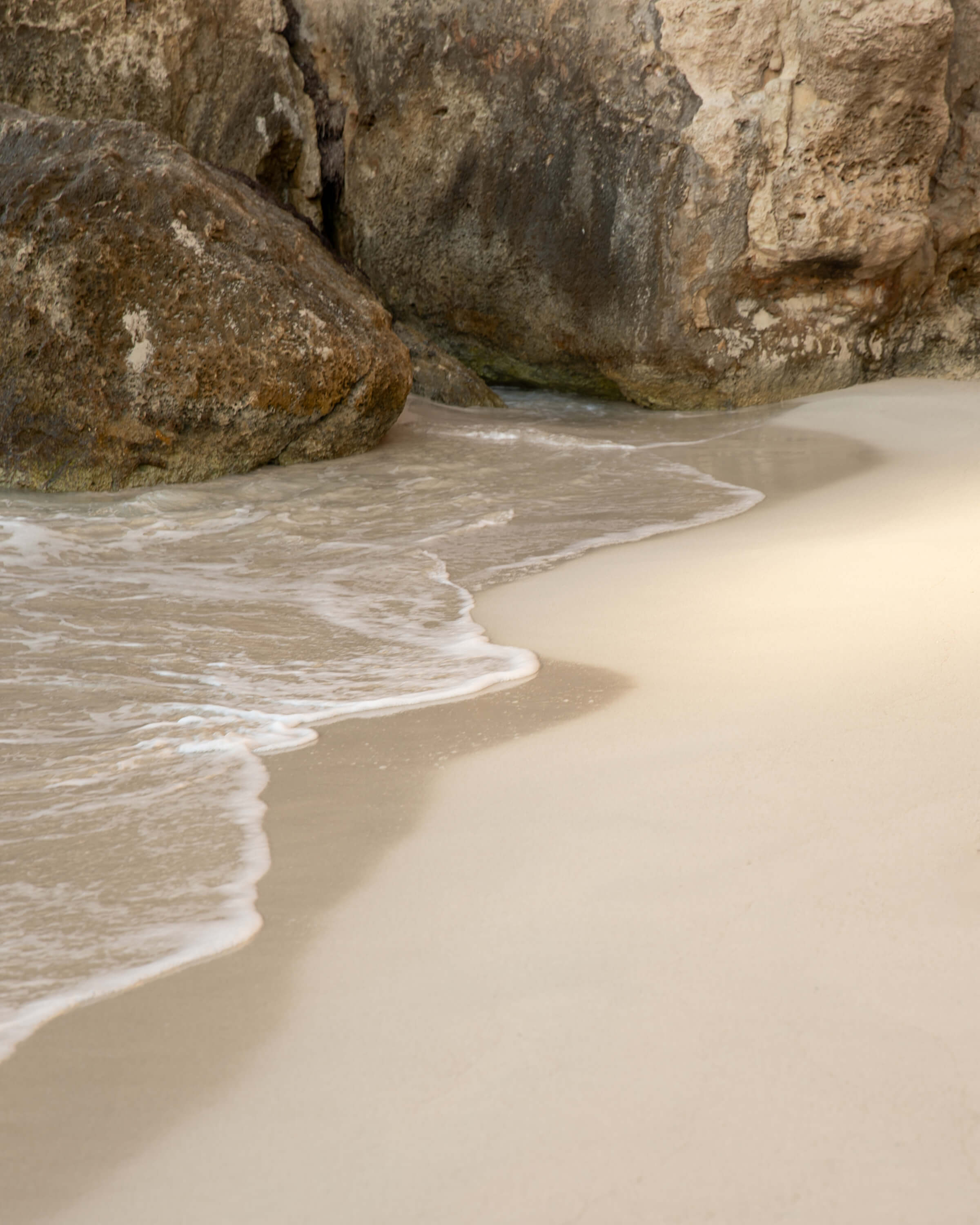 Ocean Beach Gentle waves wash soft sand beneath rugged cliffs.