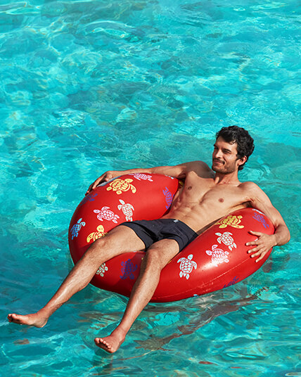 Man on a Vilebrequin Inflatable Buoy