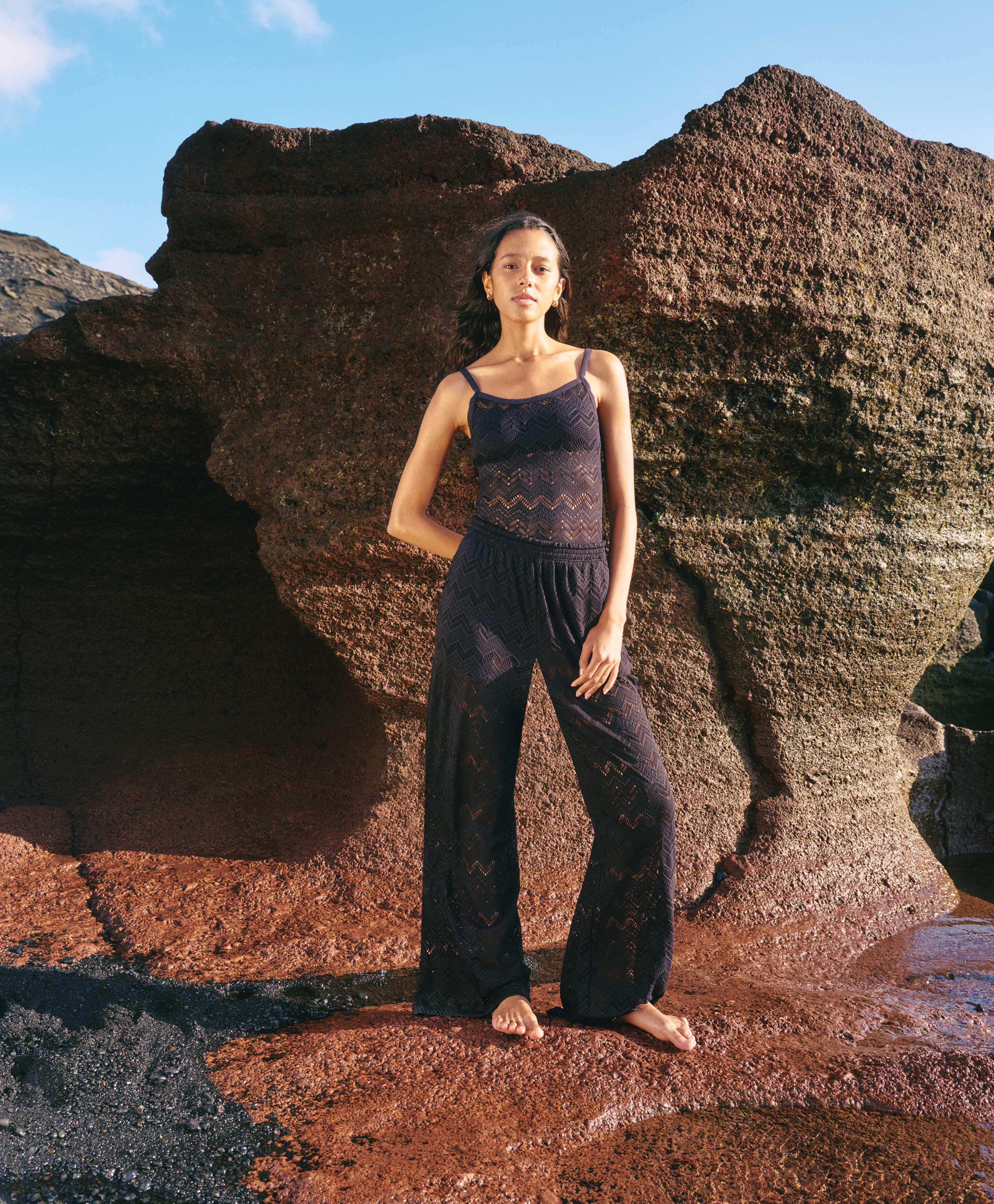 Woman on the beach wearing black dentelle pants