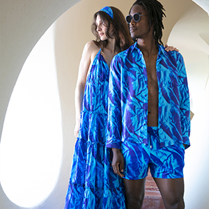 A woman wearing the Women Cotton Long Backless Dress Les Draps Froissés and a man wearing the Shirt and a Swimshort Les Draps Froissés