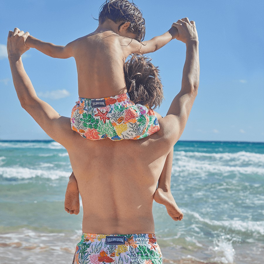 Father and son wearing matching father and son swim shorts