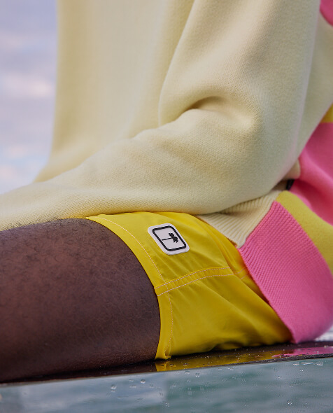 Men's solid yellow swim trunks