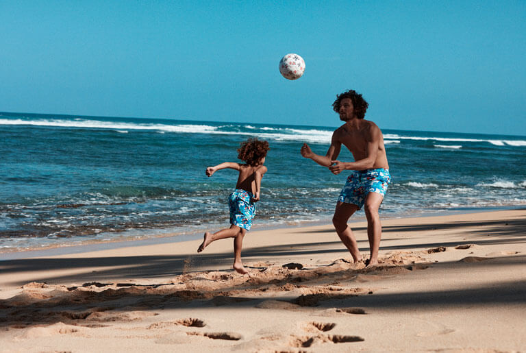 Father and his son playing volleyball wearing a Vilebrequin swim shorts