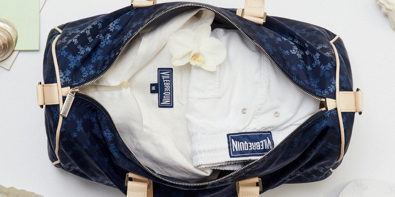 White linen shirt and men’s shorts in a travel bag for men
