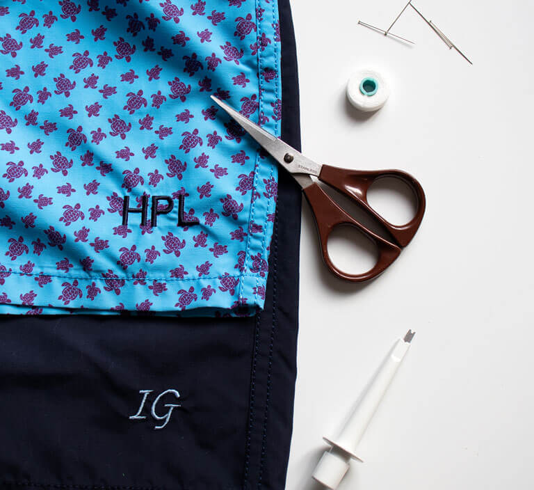 Embroidering a monogram on a men swim trunk