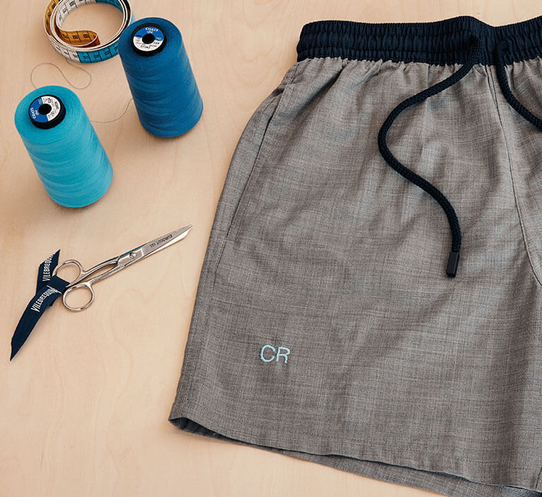 Embroidering a monogram on a men swim trunk