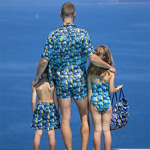 A family wearing matching swimwear for men and kids