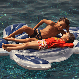 One boy and one girl on a turtle buoy