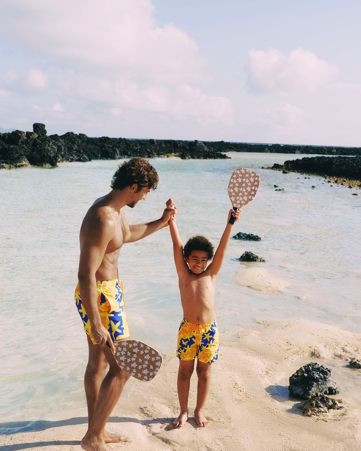 man and a kid with matching Vilebrequin swimwears on the beach