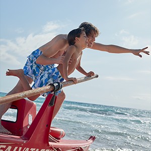 Father and son wearing matching father and son swim shorts