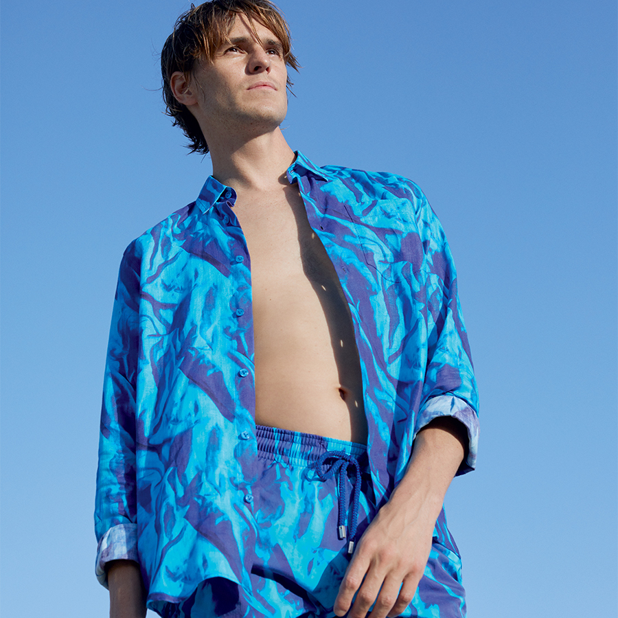 A man wearing the Les Draps Froissés Shirt with the Les Draps Froissés Swimshort