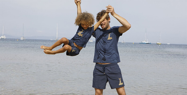 A man and a boy both wearing the swim short and a t-shirt The Year of the Rabbit