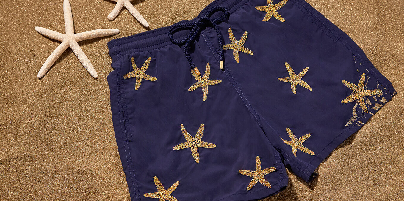 Blue men's swimsuit embroidered with gold starfish threads