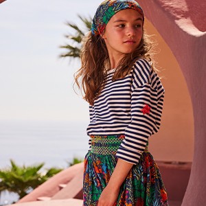 A girl wearing a skirt and a top