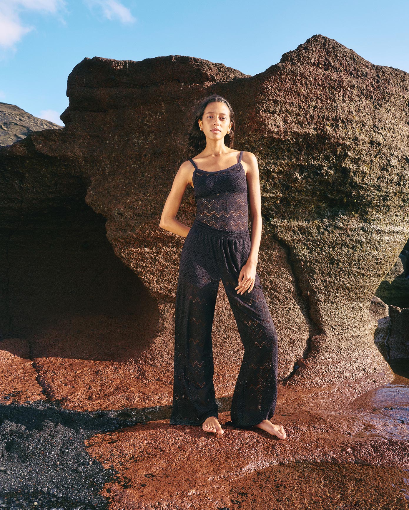 Woman on the beach wearing black dentelle pants