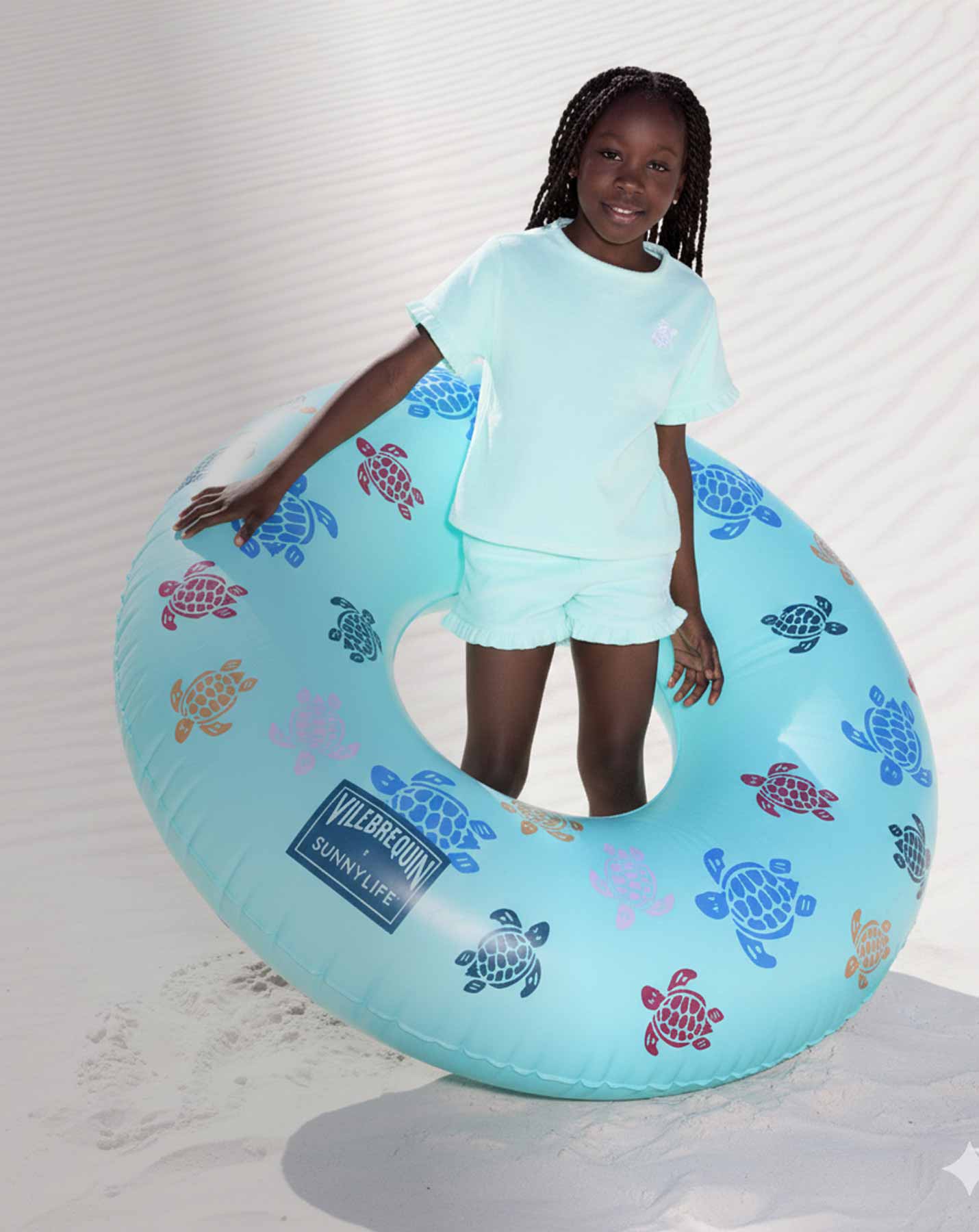 Girl wearing tie and dye dress with sunglasses and white cap