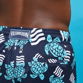 Picture of Men Short classic Printed - Men Swimwear Short and Fitted Stretch- Plastic Odyssey x Vilebrequin, Navy details view 3 Picture of Men Short classic Printed - Men Swimwear Short and Fitted Stretch- Plastic Odyssey x Vilebrequin, Navy details view 3