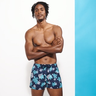 Picture of Men Short classic Printed - Men Swimwear Short and Fitted Stretch- Plastic Odyssey x Vilebrequin, Navy front worn view Picture of Men Short classic Printed - Men Swimwear Short and Fitted Stretch- Plastic Odyssey x Vilebrequin, Navy front worn view